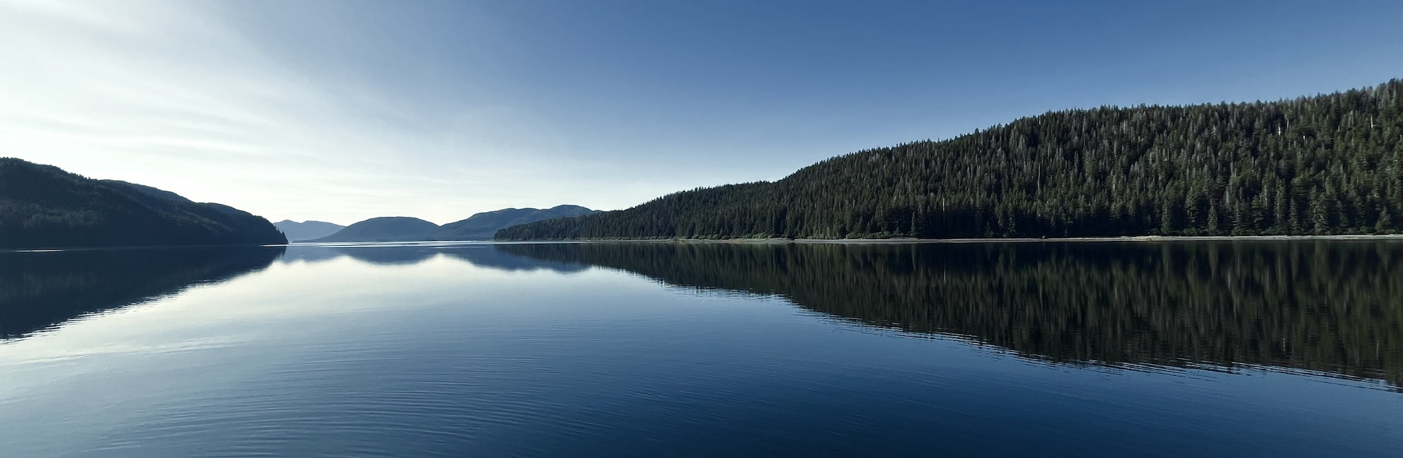 A view of the Inside Passage in Alaska, with mountains and water.